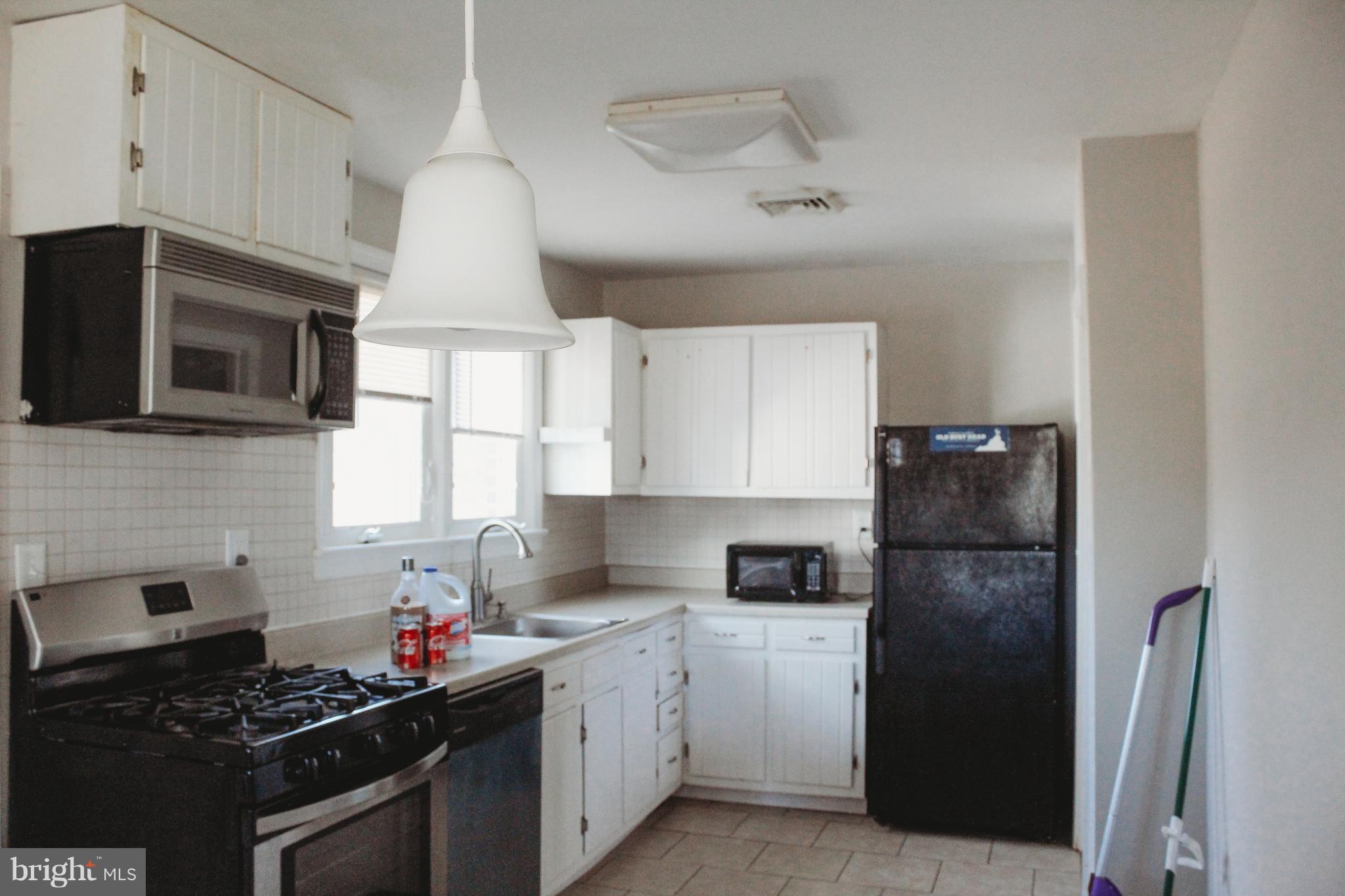 9101 Sudley Road Manassas, VA 20110 - Photo 6 of 19 a kitchen with a sink stove and refrigerator