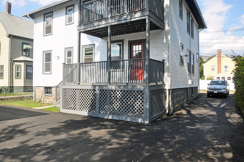 135-137 Thacher Street, Unit 2 Milton, MA 02186 - Photo 11 of 11 a front view of a house with a yard