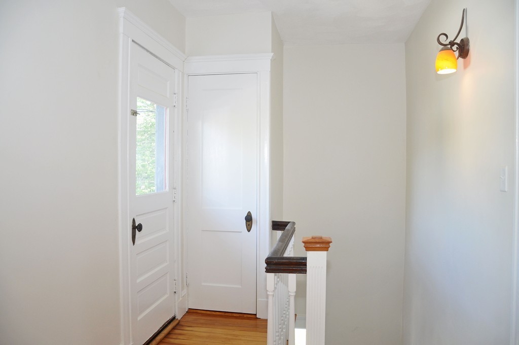 135-137 Thacher Street, Unit 2 Milton, MA 02186 - Photo 2 of 11 a bathroom with a light fixture and a sink
