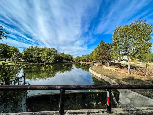 a view of a lake with a bench next to a lake
