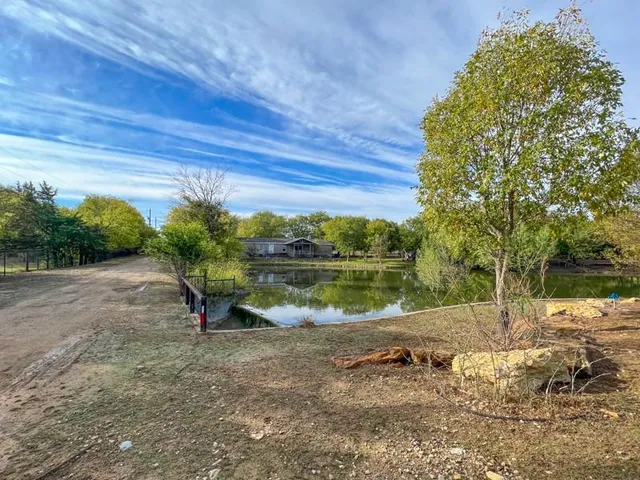 a view of swimming pool with outdoor space and lake view