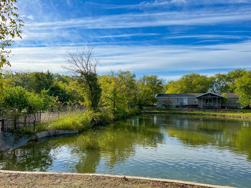 14205 Old Denton Road Roanoke, TX 76262 - Photo 22 of 29 a view of a lake with a house in the background
