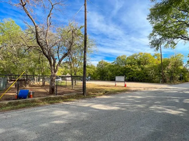 a view of a road with a building in the background