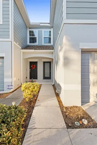 a kitchen with a sink a refrigerator and cabinets