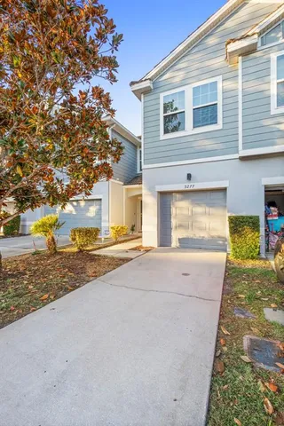 a view of a kitchen with kitchen island a counter top space appliances and cabinets