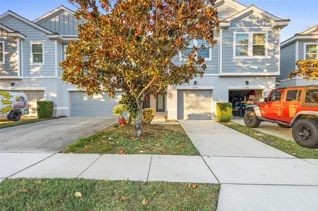 a kitchen with stainless steel appliances granite countertop a stove top oven a sink dishwasher a dining table and chairs with wooden floor