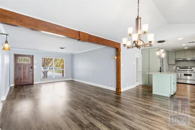 a view of a livingroom with a furniture wooden floor and window