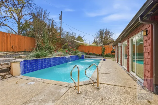 a view of swimming pool with a patio