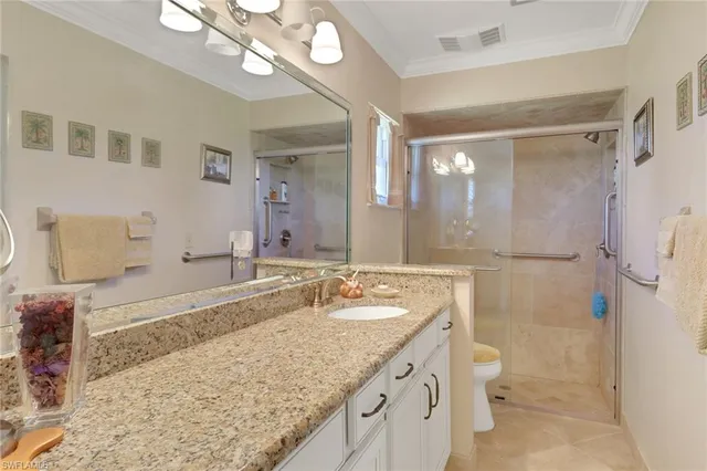 a bedroom with a bed and a flat tv screen on dresser