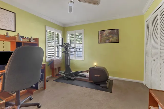 a bathroom with a granite countertop sink a toilet a mirror and shower