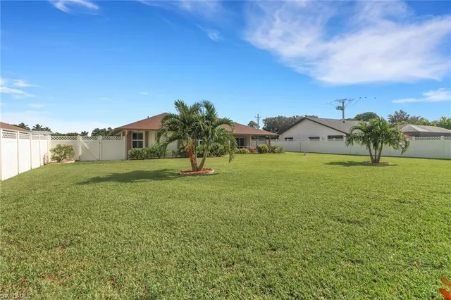 a garden with trees in the background