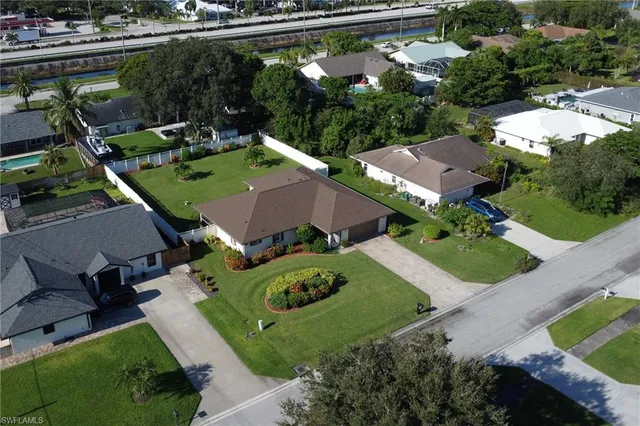 an aerial view of a house with yard swimming pool and outdoor seating