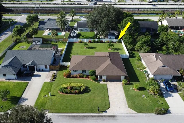 an aerial view of a house with garden space and street view