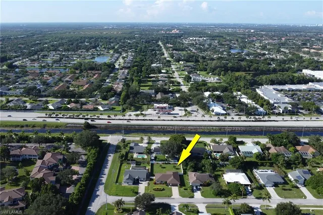 an aerial view of a house with yard swimming pool and outdoor seating