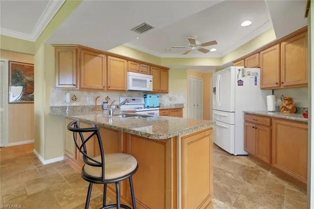 a kitchen with stainless steel appliances granite countertop a sink stove and cabinets