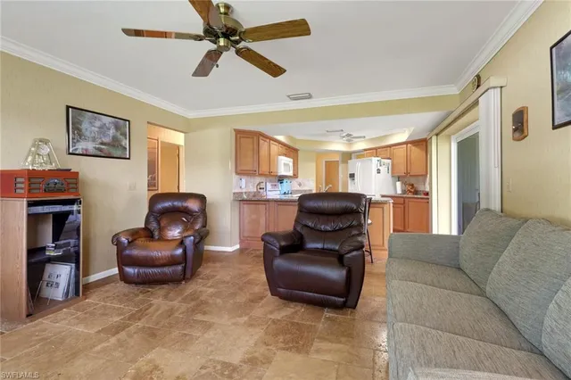 a kitchen with stainless steel appliances granite countertop a table chairs sink and cabinets