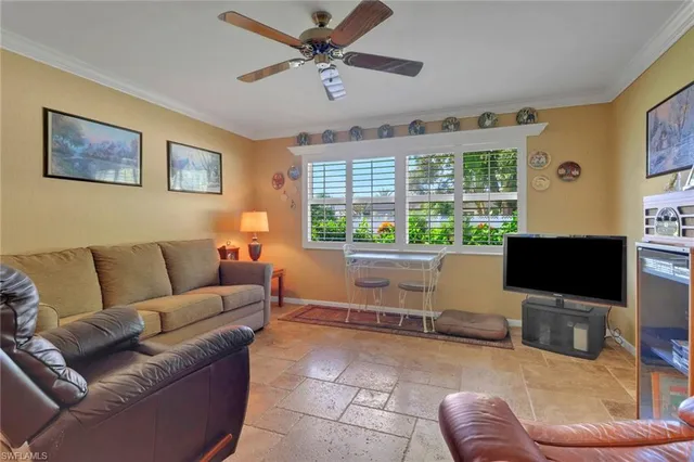 a living room with furniture ceiling fan and a rug