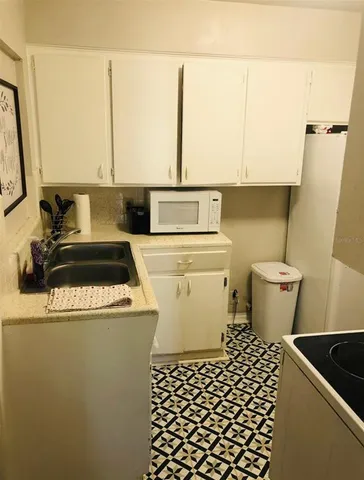 a white toilet sitting next to a sink