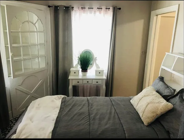 a bedroom with a bed and a window