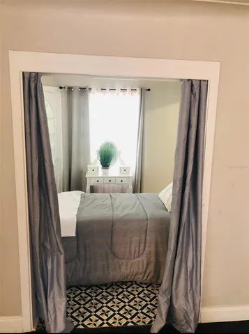 a bedroom with a bed and a window
