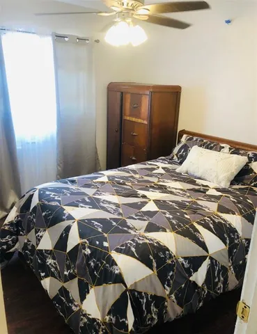 a bedroom with a bed and a mirror