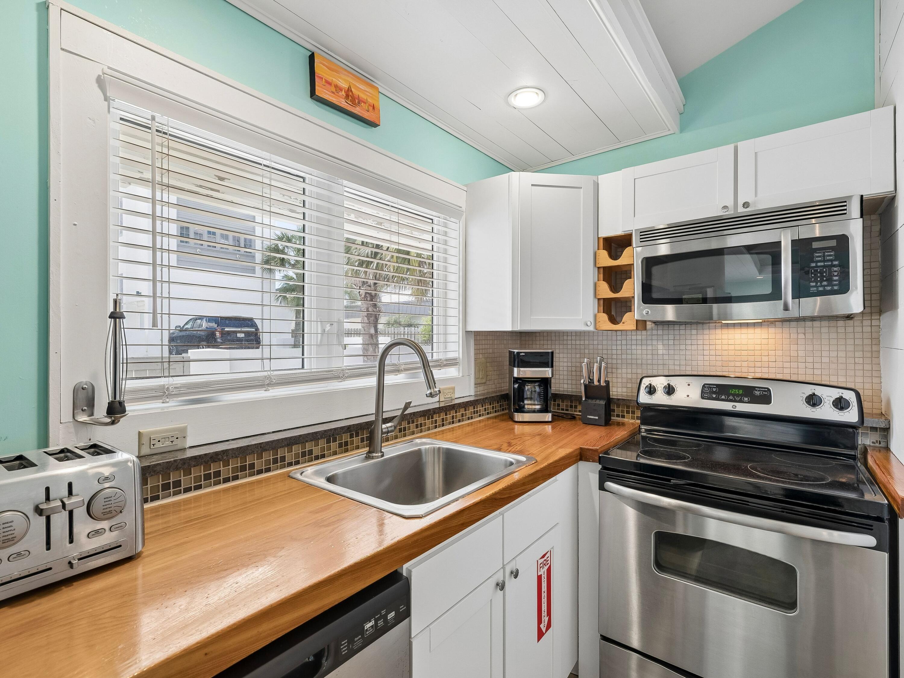 36 Green Street Inlet Beach, FL 32461 - Photo 9 of 27 a kitchen with a sink stove and microwave