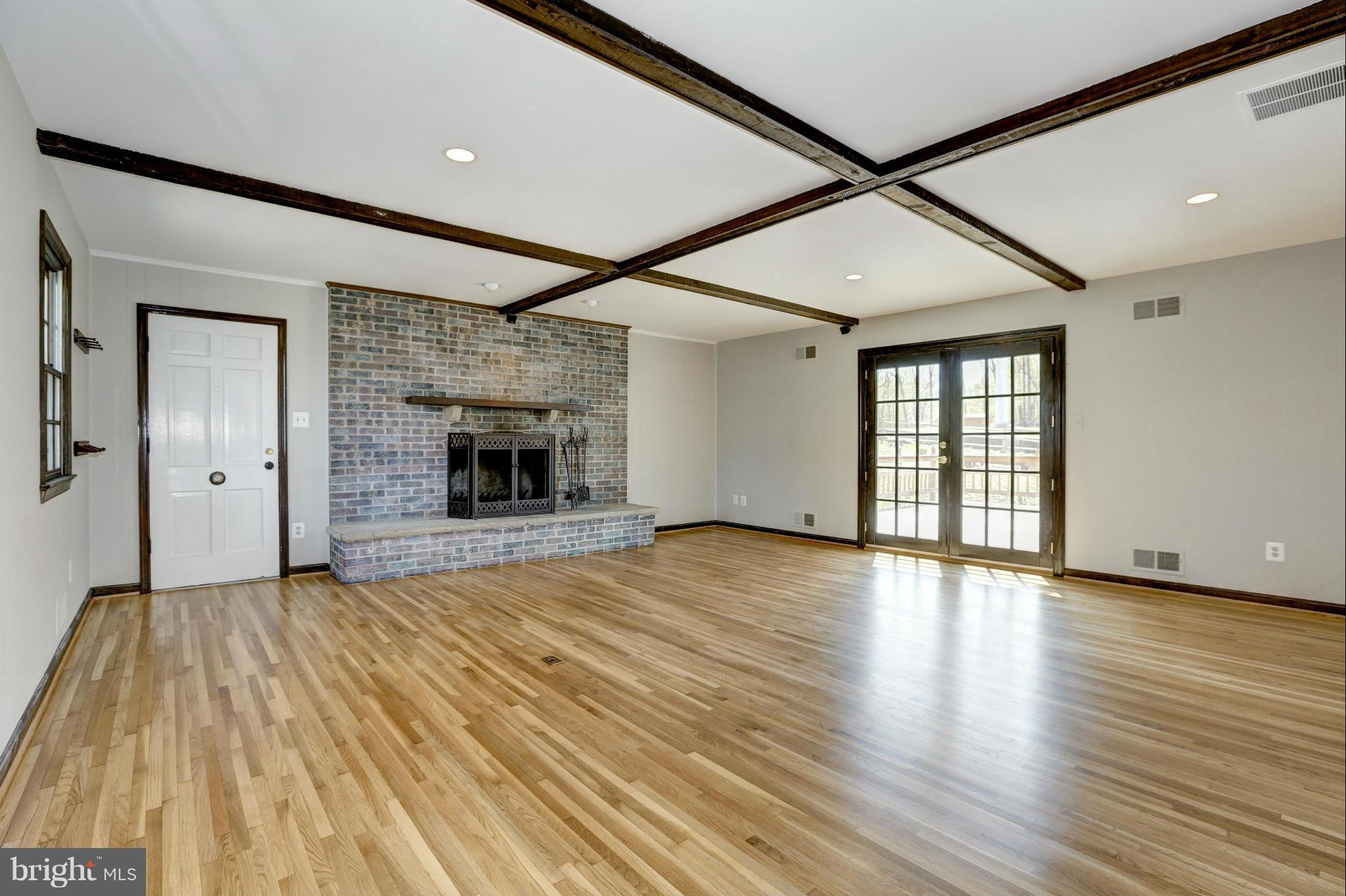 13116 Brandon Way Road Gaithersburg, MD 20878 - Photo 11 of 30 a view of an empty room with wooden floor fireplace and a window