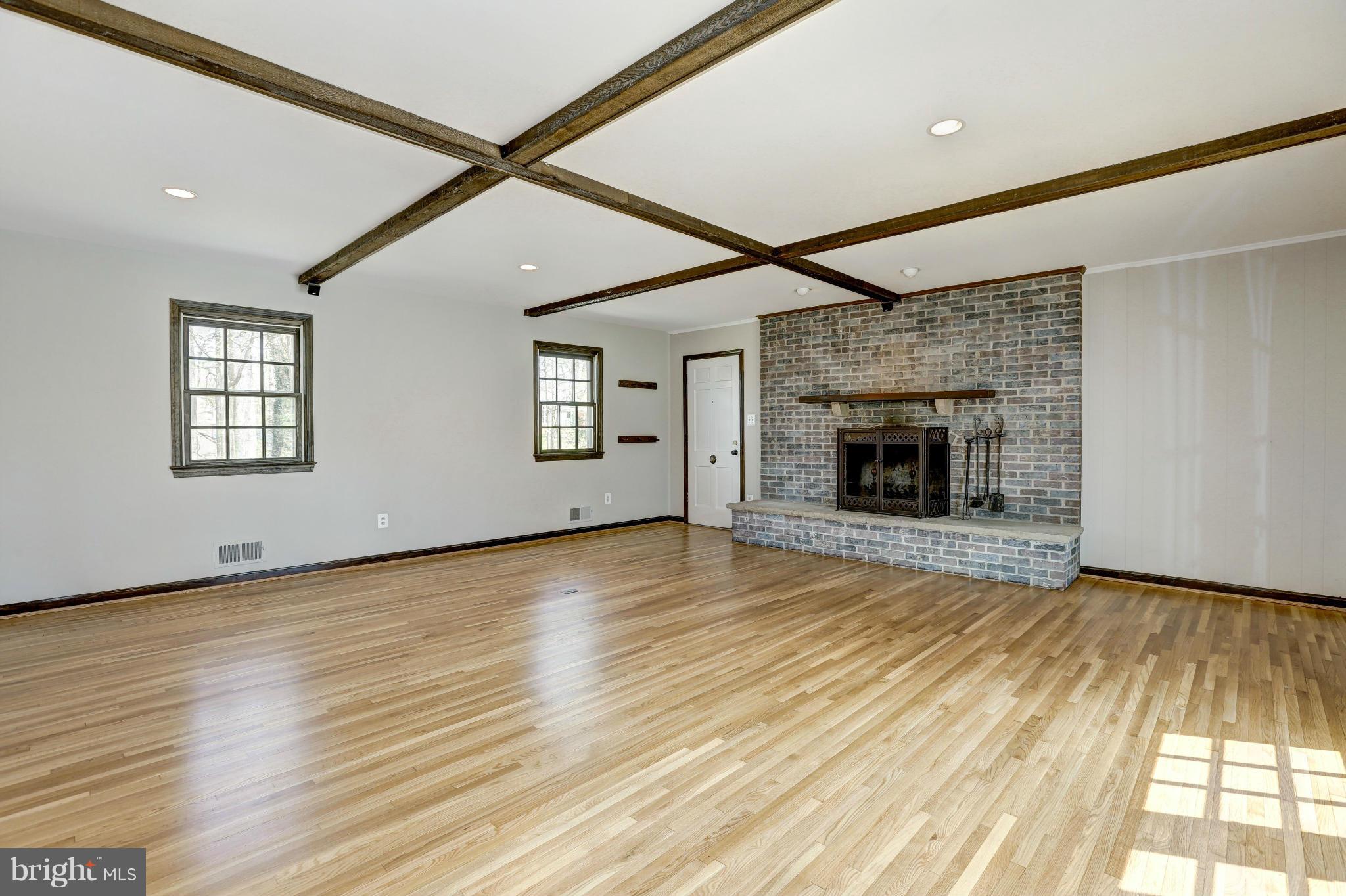 13116 Brandon Way Road Gaithersburg, MD 20878 - Photo 12 of 30 a view of empty room with wooden floor and fireplace