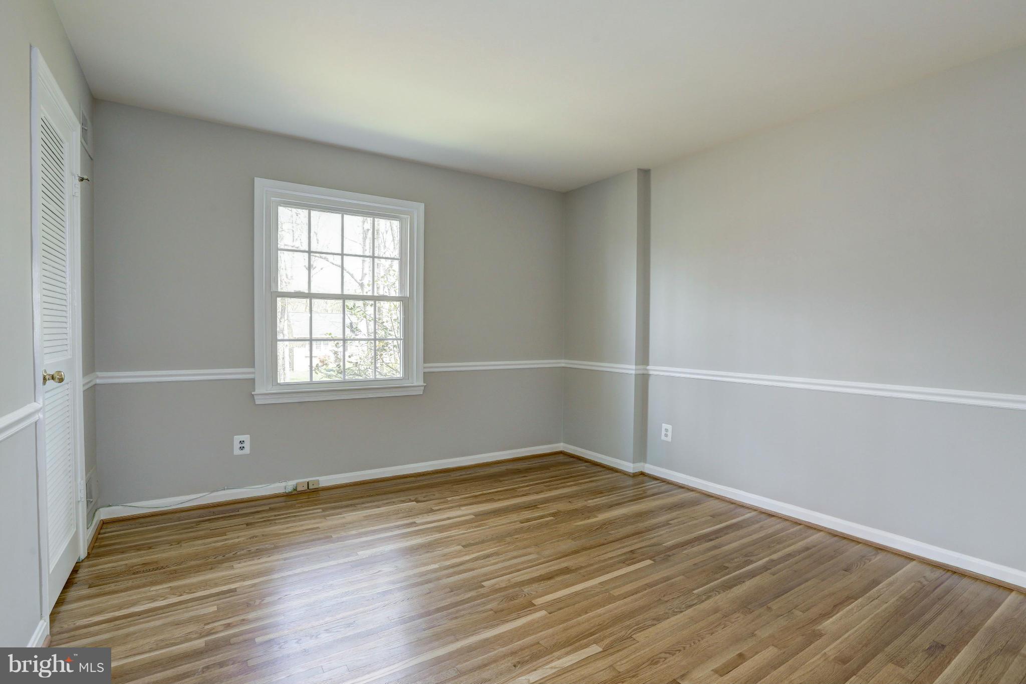 13116 Brandon Way Road Gaithersburg, MD 20878 - Photo 15 of 30 an empty room with wooden floor and windows