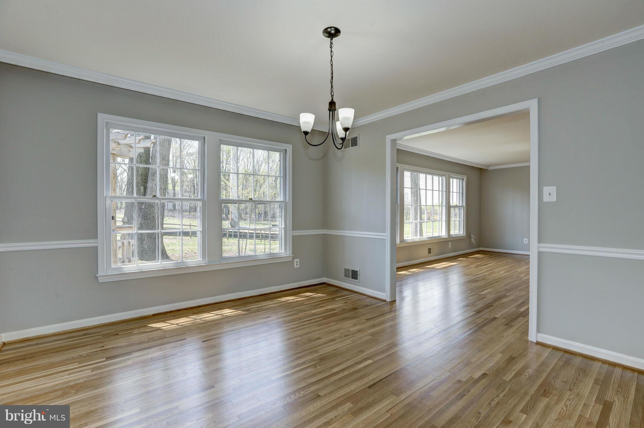 13116 Brandon Way Road Gaithersburg, MD 20878 - Photo 4 of 30 a view of a livingroom with wooden floor staircase and a kitchen