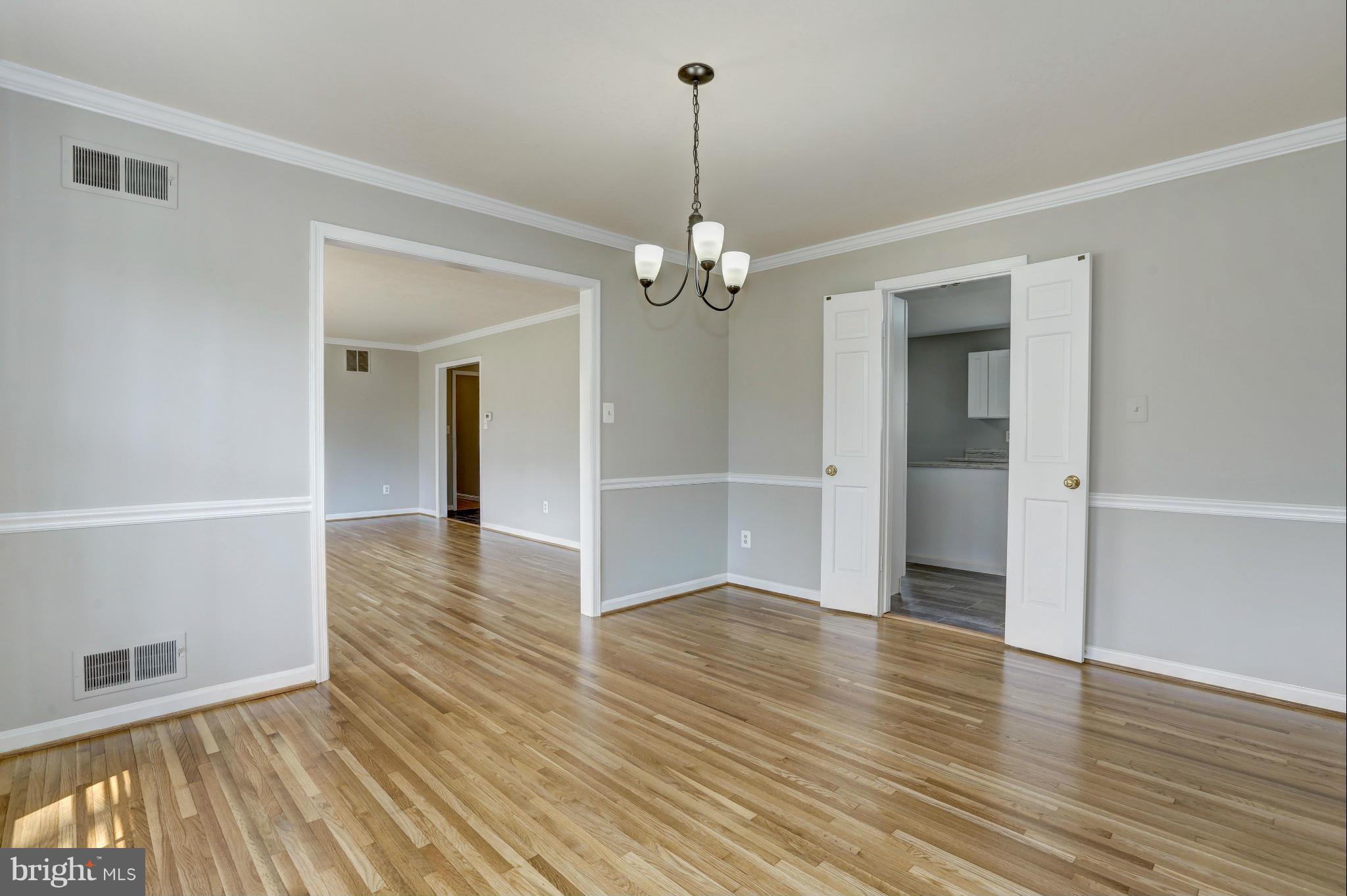 13116 Brandon Way Road Gaithersburg, MD 20878 - Photo 5 of 30 an empty room with wooden floor and windows