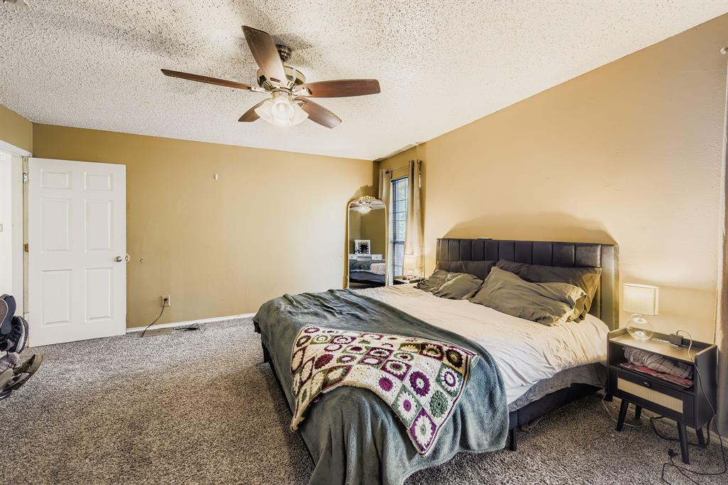 6232 North Ridge Road Fort Worth, TX 76135 - Photo 12 of 29 a bedroom with a bed and dresser