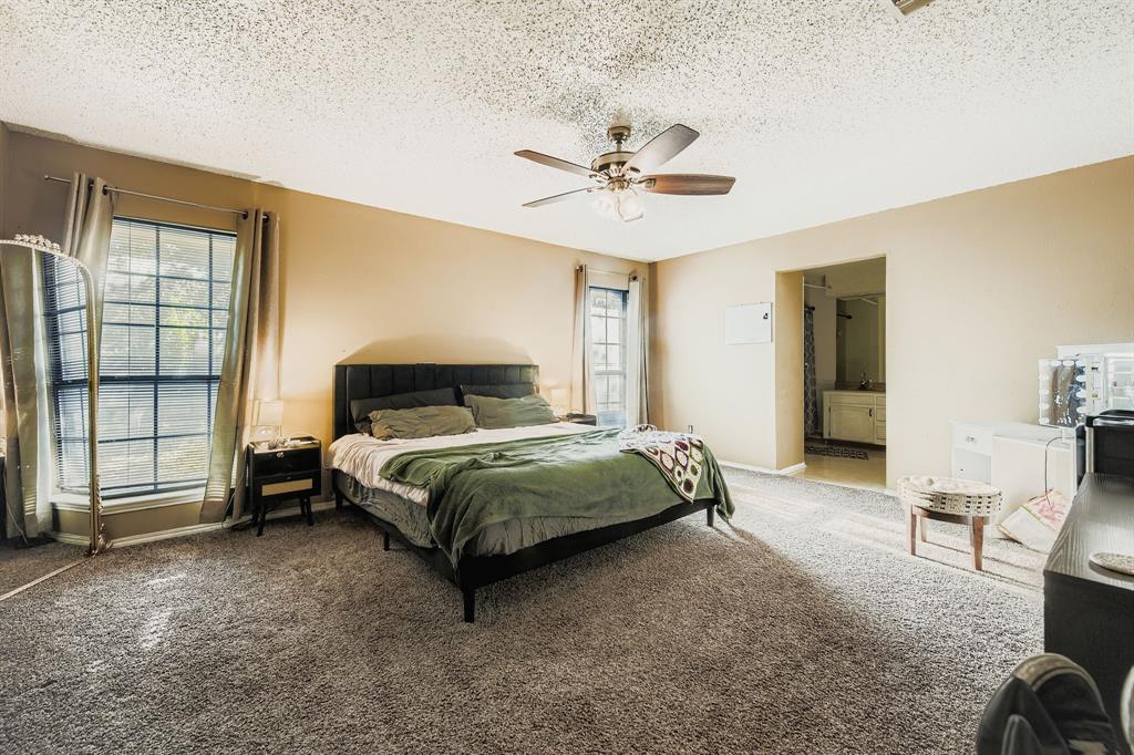 6232 North Ridge Road Fort Worth, TX 76135 - Photo 13 of 29 a bedroom with a bed and a chair