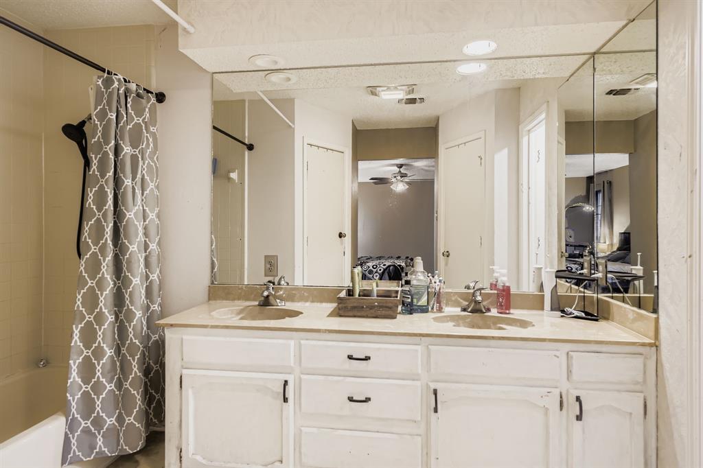 6232 North Ridge Road Fort Worth, TX 76135 - Photo 15 of 29 a bathroom with a double vanity sink mirror and shower