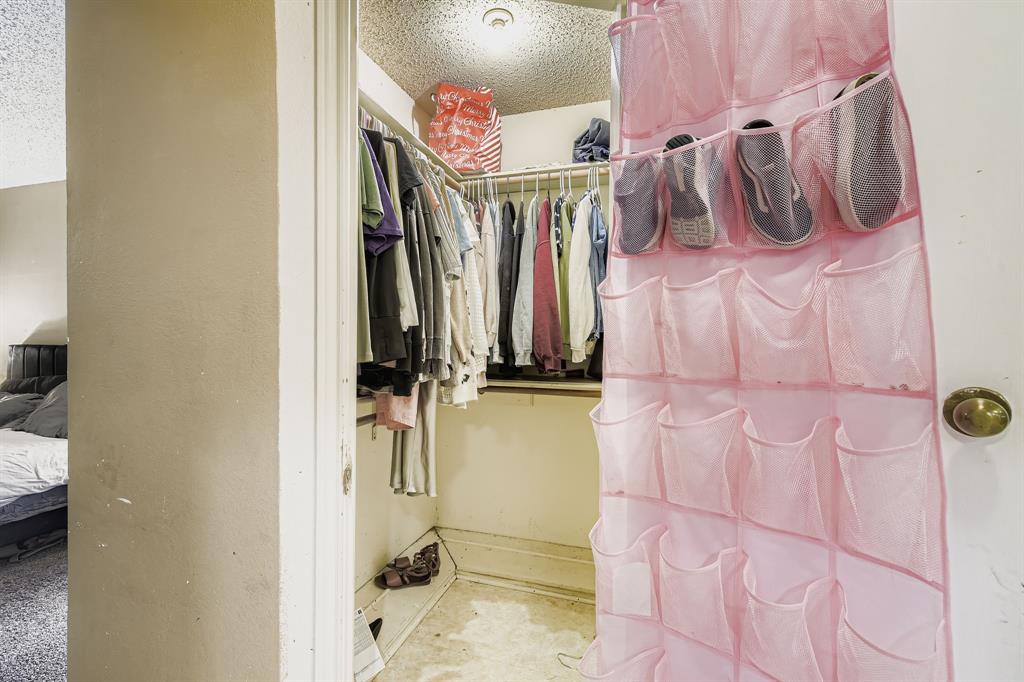 6232 North Ridge Road Fort Worth, TX 76135 - Photo 16 of 29 a view of walk in closet with clothes