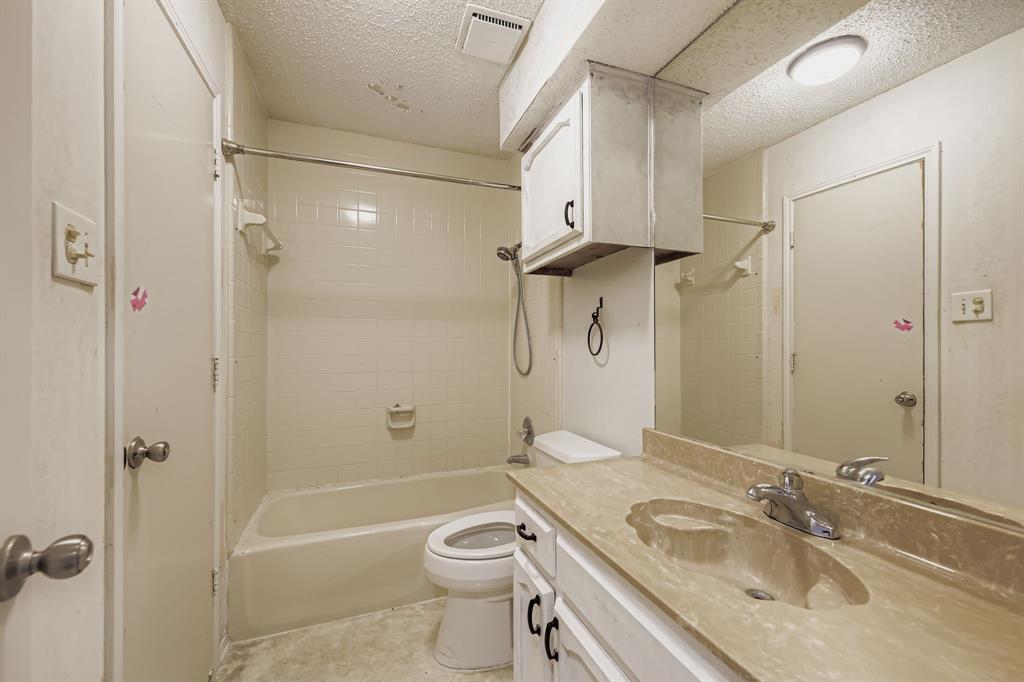 6232 North Ridge Road Fort Worth, TX 76135 - Photo 21 of 29 a bathroom with a granite countertop sink toilet and shower