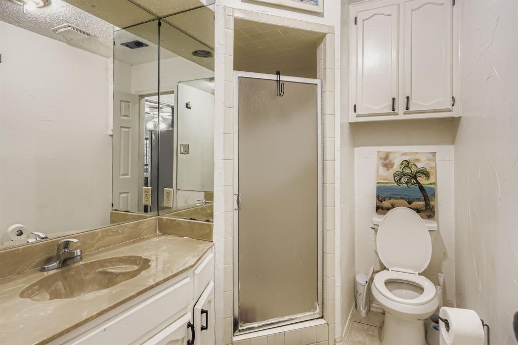 6232 North Ridge Road Fort Worth, TX 76135 - Photo 22 of 29 a bathroom with a granite countertop sink toilet and shower