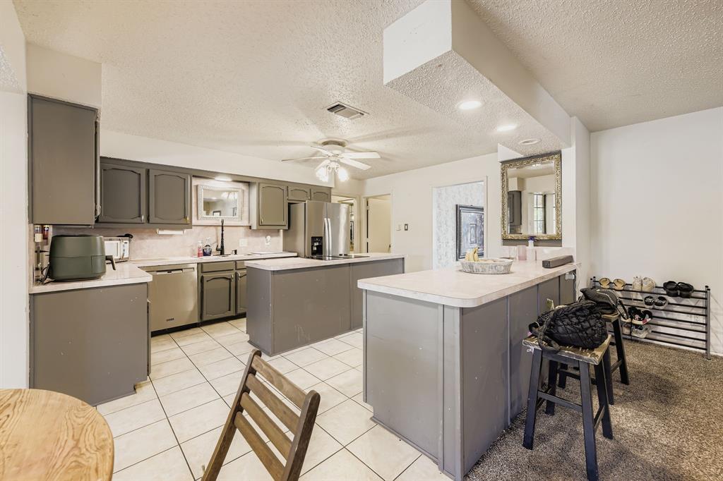6232 North Ridge Road Fort Worth, TX 76135 - Photo 7 of 29 a kitchen with a sink a counter top space and appliances
