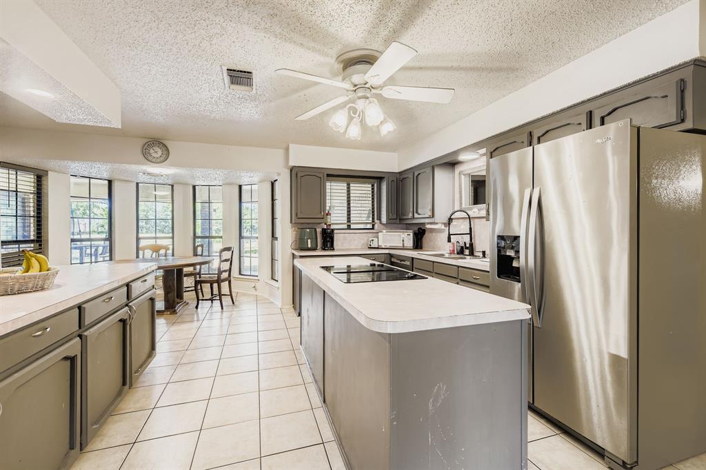6232 North Ridge Road Fort Worth, TX 76135 - Photo 8 of 29 a kitchen with stainless steel appliances a stove refrigerator sink and cabinets