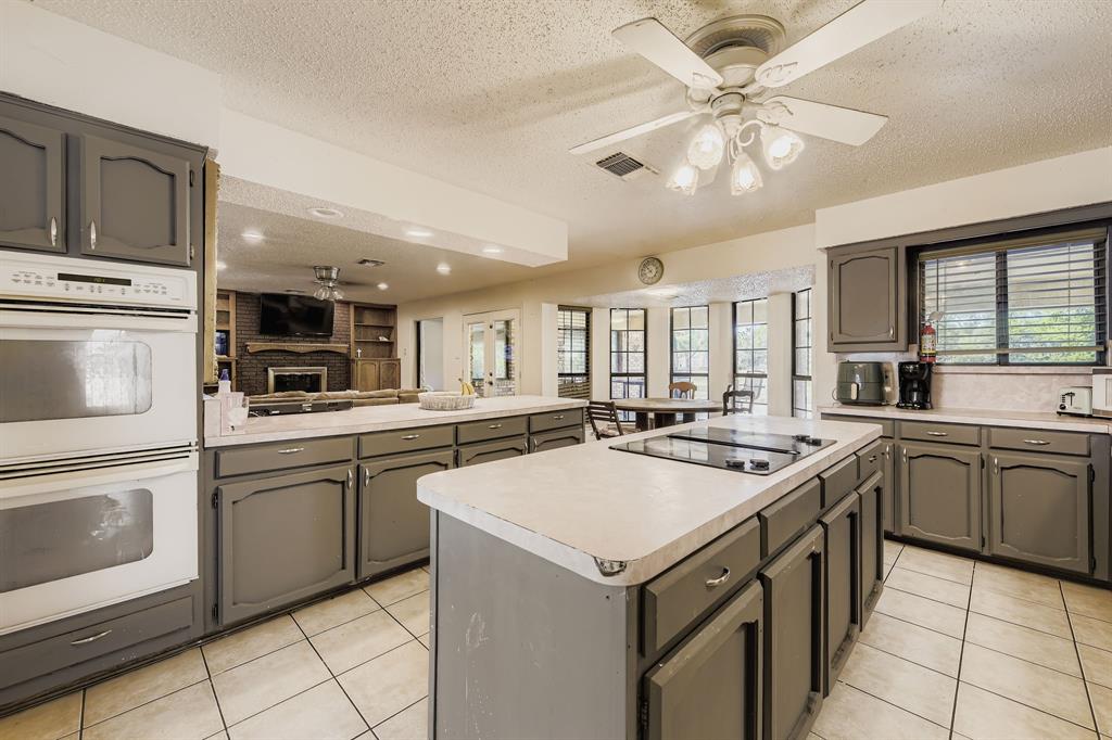 6232 North Ridge Road Fort Worth, TX 76135 - Photo 9 of 29 a kitchen with a sink a stove top oven and cabinets