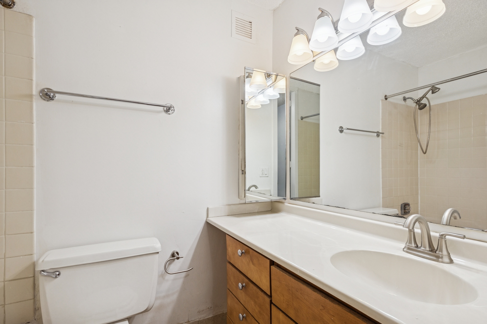 30 East Huron Street, Unit 2003 Chicago, IL 60611 - Photo 11 of 24 a bathroom with a sink a toilet and a mirror