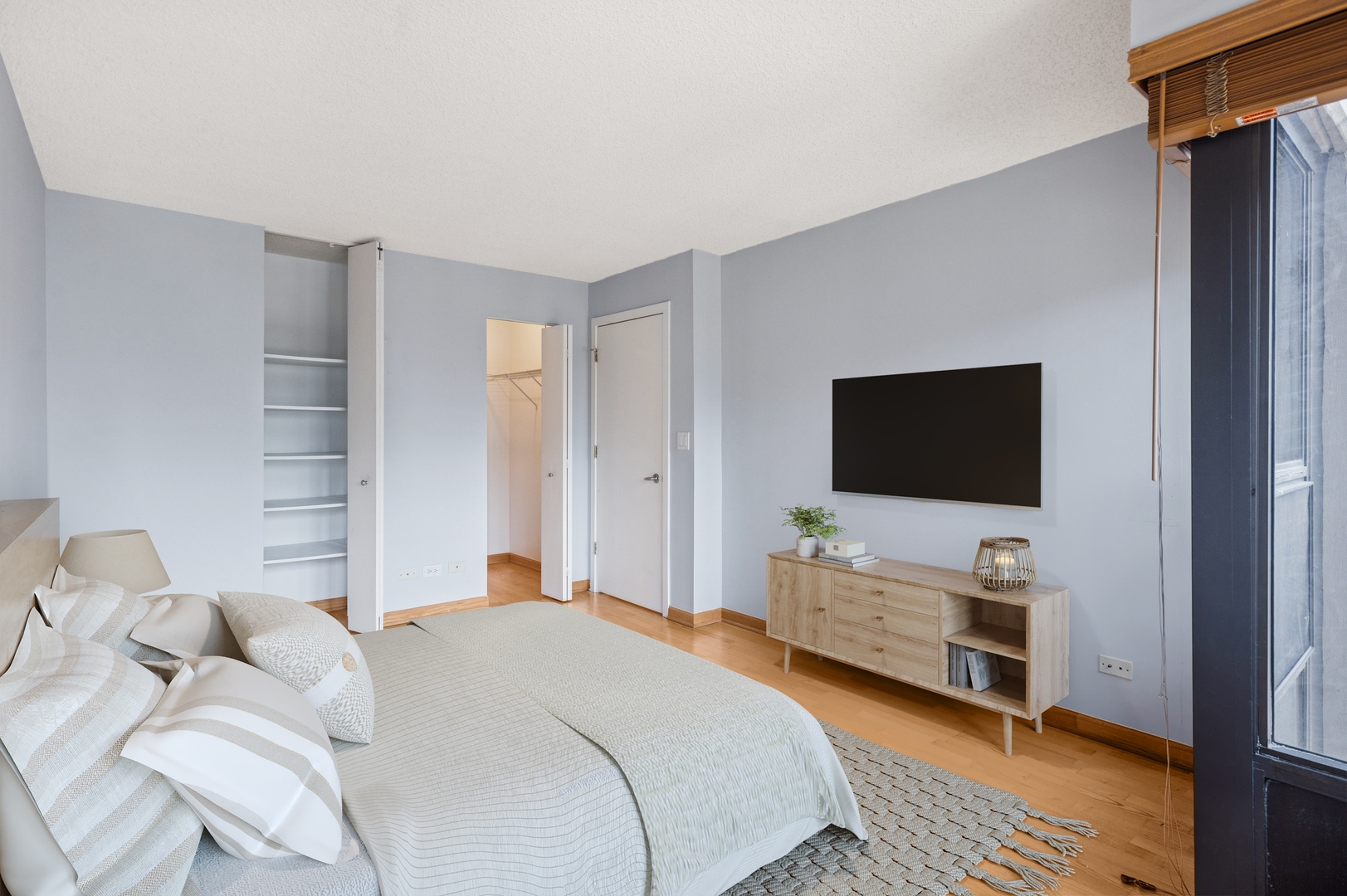 30 East Huron Street, Unit 2003 Chicago, IL 60611 - Photo 9 of 24 a bedroom with a bed and flat screen tv