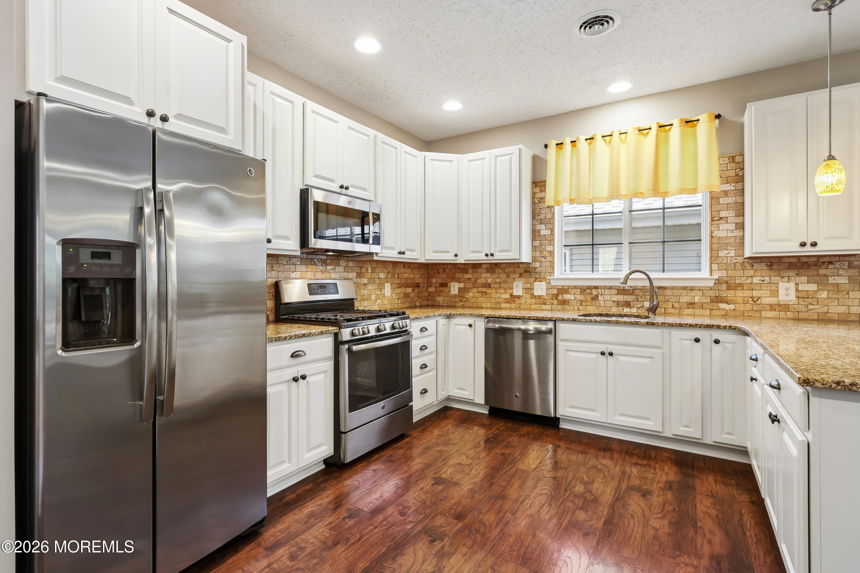 66 Sandpiper Road Barnegat, NJ 08005 - Photo 5 of 25 a kitchen with stainless steel appliances cabinets a stove and a refrigerator