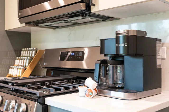 a stove top oven sitting inside of a kitchen