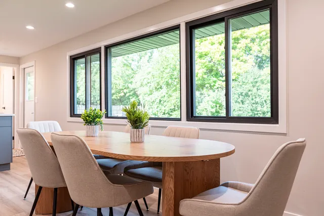 a dining room with furniture window and wooden floor