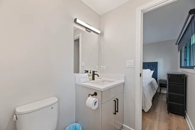a bathroom with a sink toilet and mirror