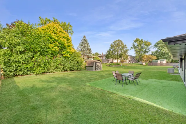 a view of a chairs and table in the garden