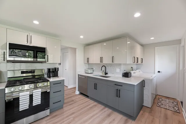 a kitchen with stainless steel appliances kitchen island granite countertop a sink and cabinets
