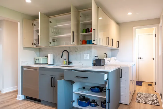 a kitchen with stainless steel appliances granite countertop a sink and wooden cabinets