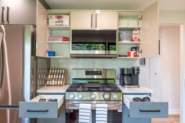 a kitchen with stainless steel appliances granite countertop a stove and a refrigerator